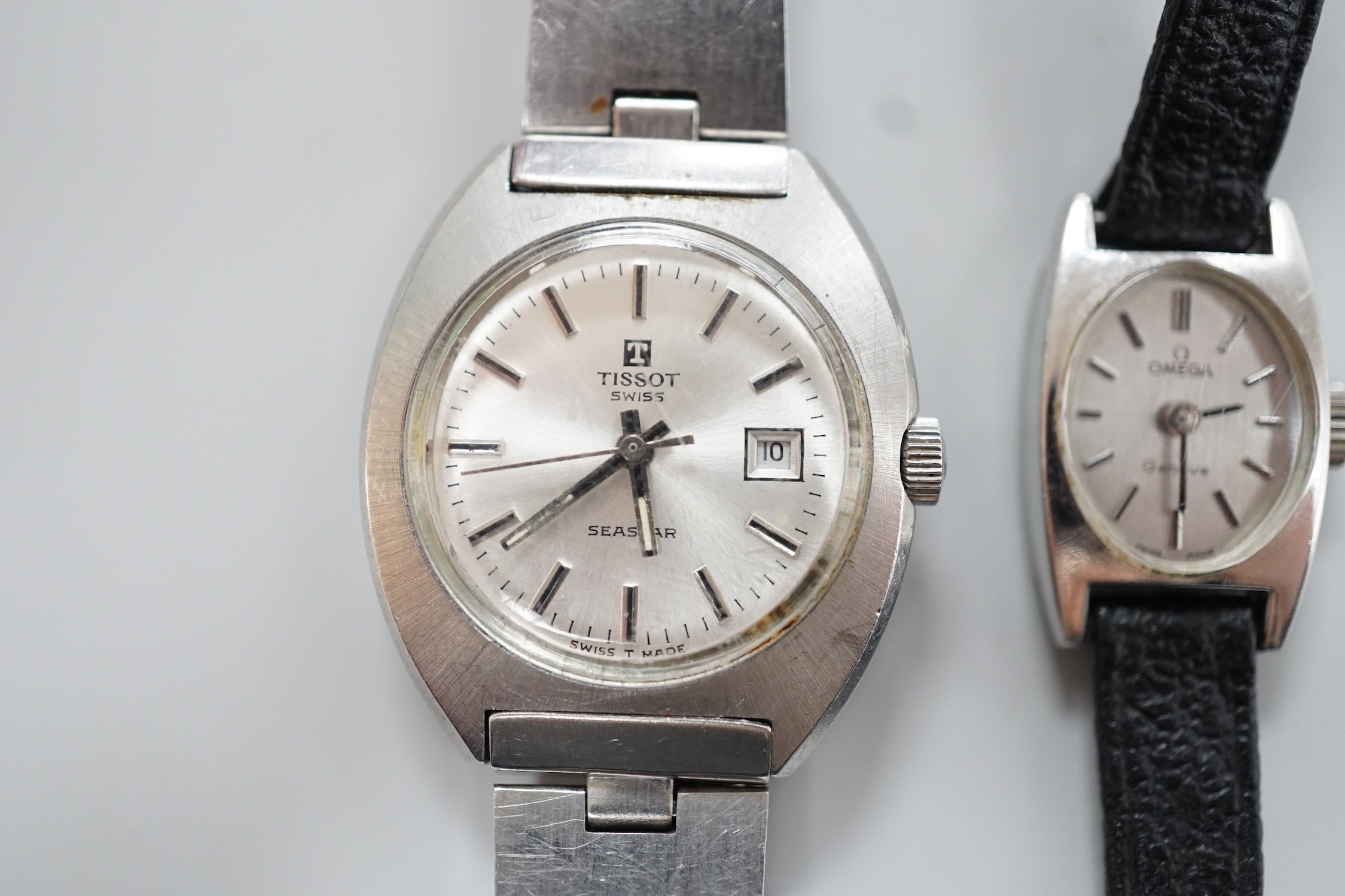 A lady's stainless steel Omega manual wind wrist watch, case diameter 16mm, with Omega box and a similar Tissot wrist watch.